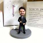 Figurine à tête branlante personnalisée en costume, assise sur un sac d'argent